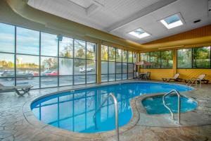 a pool in a hotel room with a view of a parking lot at Baymont by Wyndham Branson - On the Strip in Branson