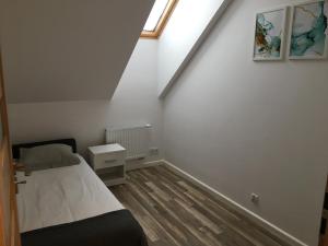 a small bedroom with a bed and a window at apartament in Rzeszów