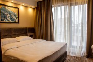 Ένα ή περισσότερα κρεβάτια σε δωμάτιο στο NEW Garni Hotel FILIA