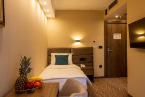Ένα ή περισσότερα κρεβάτια σε δωμάτιο στο NEW Garni Hotel FILIA