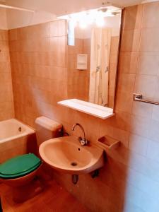 a bathroom with a sink and a toilet and a mirror at Apartments Asija in Brela +32 photos