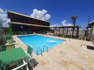 a large swimming pool in front of a building at Casarão da Praia - Itaipuaçu, Jardim Atlântico, Maricá in Itaipuaçu