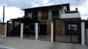 dom z bramą przed nim w obiekcie Residencial Praia da Cal - Angelita w mieście Torres