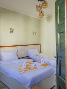 two beds in a room with towels on them at Geo Palace in Dahab +28 photos