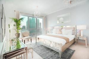 a bedroom with a large bed and a chandelier at Elite Royal Apartment - Full Burj Khalifa & Fountain view - Ambassador in Dubai