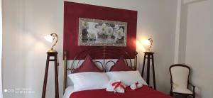 a bedroom with a bed with a red head board at B&B Palazzo Armini in Rogliano