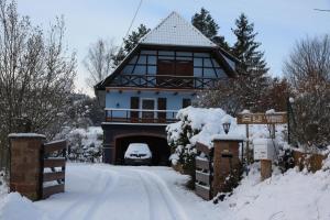a house with a garage in the snow at Au numéro 6 in Obersteinbach