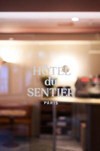 a sign for a hotel de sentier paris at Hôtel du Sentier in Paris