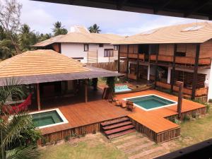 an aerial view of a house with a deck and a swimming pool at Akua Concept - Taipu de Fora in Marau