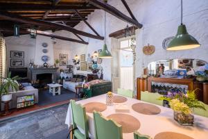 a room with a table and chairs and a living room at Casa Tradicional da Vila in Vila Franca do Campo