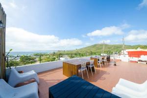 a balcony with a table and chairs and the ocean at Lanhiwan Inn in Nanwan