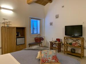 a bedroom with a bed and a tv and a window at Rosamare in Cesenatico