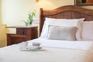 a bed with a tray with a cup and aucer on it at La Galería in Donostia-San Sebastián