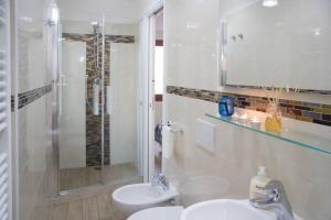 a bathroom with a sink and a shower and a toilet at Ca' Venice Canal View in Venice +18 photos