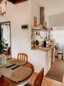 a kitchen with a wooden table and a dining room at Granny's farm in São Vicente