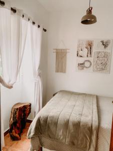 a bedroom with a bed and a window at Granny's farm in São Vicente