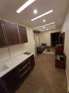 a room with a kitchen and a living room at Reef Al-Hijrah Furnished Apartments in Al Madinah