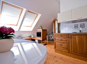 a living room with a table and a kitchen with windows at Old Town Riga in Rīga