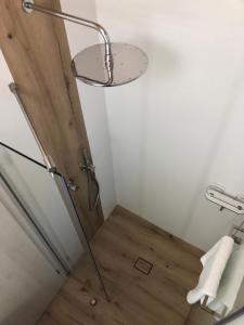 y baño con ducha y suelo de madera. en Ferienwohnung Zückner, Fränkisches Seenland, en Georgensgmünd