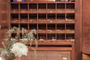 a wooden book shelf with flowers in a vase at La Galería in Donostia-San Sebastián