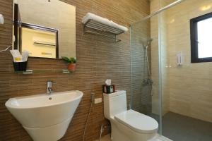 a bathroom with a sink and a toilet and a shower at Gully Orchard Homestay in Jialin +34 photos
