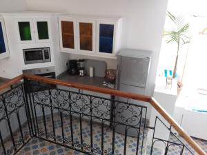 a view of a kitchen from the balcony of a house at ESCALE PARADIS 10 pers 4 ch 3 sdb piscine in Aourir