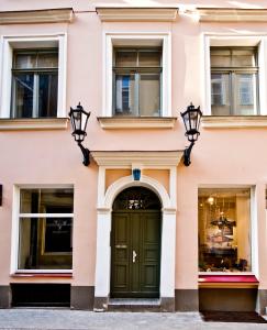 a pink building with a green door at Old Town Riga in Rīga