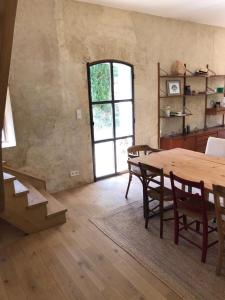 a dining room with a table and chairs and a window at La Ferme de Saint Christeau in Auch