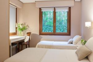 Postel nebo postele na pokoji v ubytování Hotel Monte Ulia