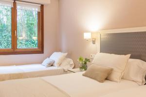 Postel nebo postele na pokoji v ubytování Hotel Monte Ulia