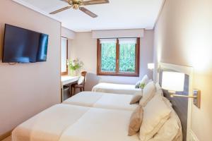 Postel nebo postele na pokoji v ubytování Hotel Monte Ulia