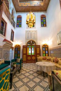 - un grand salon avec un lustre dans un bâtiment dans l'établissement Dar El Ouedghiri, à Fès