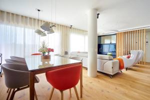 a living room with a table and chairs and a couch at D&R penthouse on the beach in Málaga