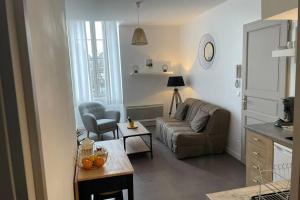 sala de estar con sofá y mesa en logement entier 33 m2 à Pau, en Pau