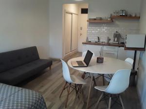 a living room with a table and a laptop on it at Avenida Corrientes Studio - Obelisco in Buenos Aires