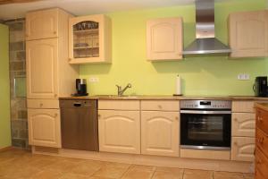 a kitchen with white cabinets and a stove top oven at Alt-Gailingen in Gailingen