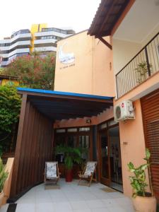 a building with two chairs outside of it at Hotel Charme Fonte do Boi in Salvador