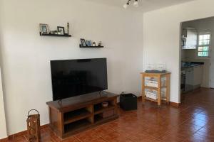 a living room with a flat screen tv on a wall at Apartamento Bastian Casas Verdes in Costa Teguise
