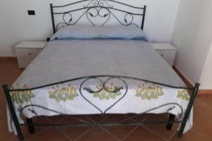 a bedroom with a bed with a metal frame at Appartamento Casa Rossa in Crotone