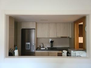 a kitchen with a refrigerator and a sink at Dúplex a la Massana a 25 metres del telecabina de pal 612 in La Massana