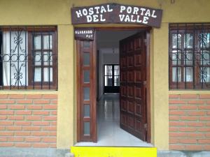 an entrance to a building with a wooden door at Hostal Portal del Valle in Cafayate