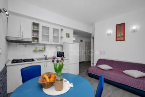 a kitchen and living room with a table and a couch at BeachView Apartments in Drasnice in Drašnice