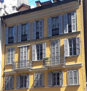 gelbes Gebäude mit weißen Fenstern und Balkonen in der Unterkunft Suite Pantano5 in Mailand