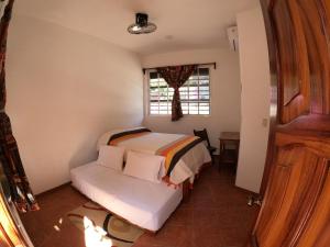 Giường trong phòng chung tại Casa Lomas del Marinero Internet Starlink SIN GARAJE
