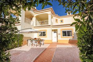 an image of a villa with a table and chairs at Moreton A in Portimão