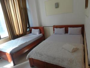 Postel nebo postele na pokoji v ubytování Thuong Hai Hotel
