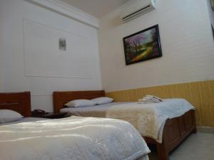 Postel nebo postele na pokoji v ubytování Thuong Hai Hotel