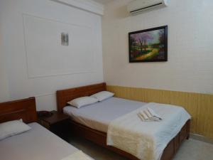 Postel nebo postele na pokoji v ubytování Thuong Hai Hotel