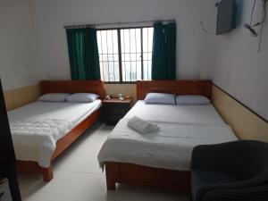 Postel nebo postele na pokoji v ubytování Thuong Hai Hotel