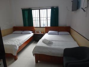 Postel nebo postele na pokoji v ubytování Thuong Hai Hotel + 17 fotografií